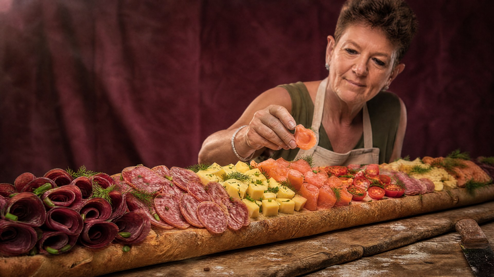 Andrea Schelbert formt und belegt Meterpartybrote in ihrer Catering-Küche